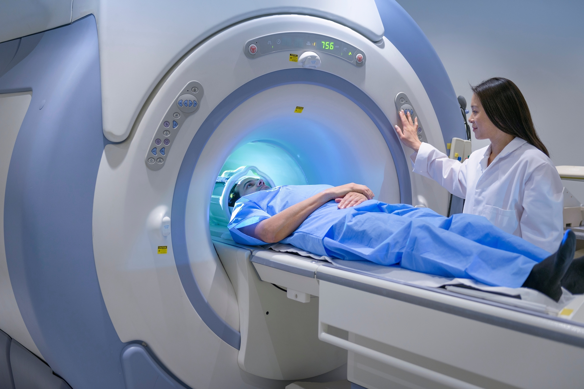 A patient in an MRI scanner with a technician
