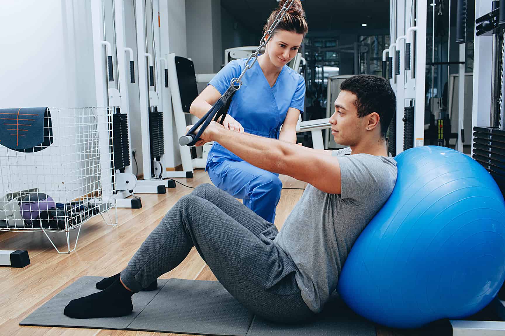 A physical therapist guiding a patient through an exercise