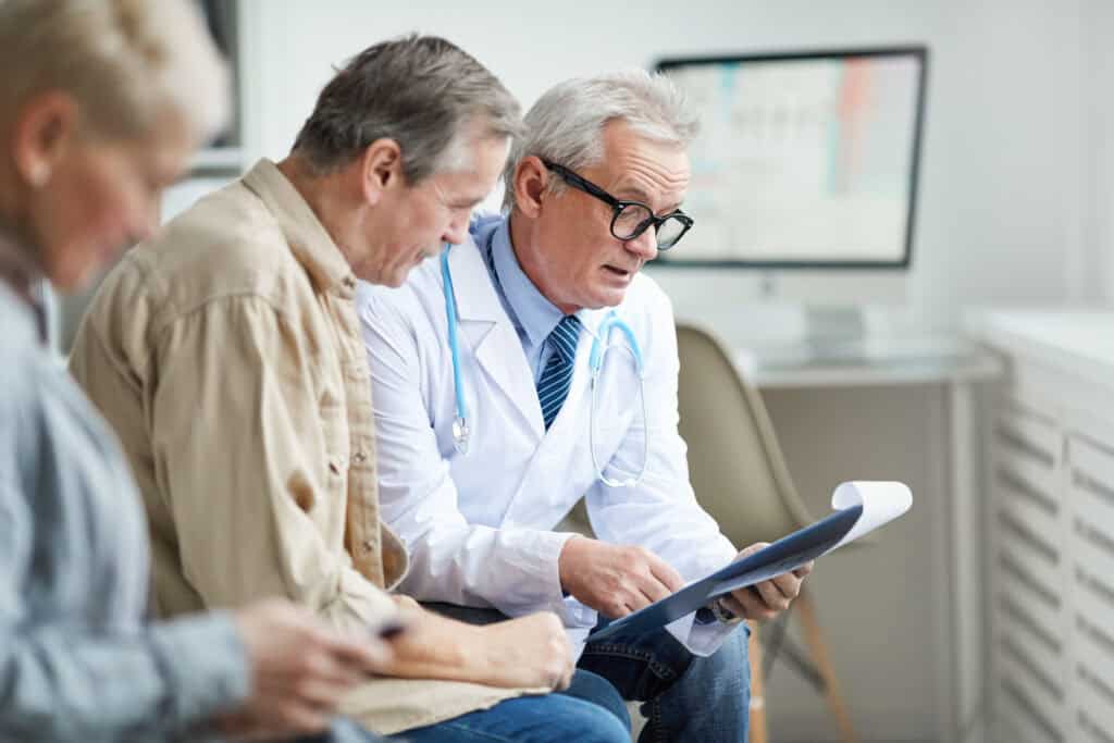 A doctor going over results with an older couple