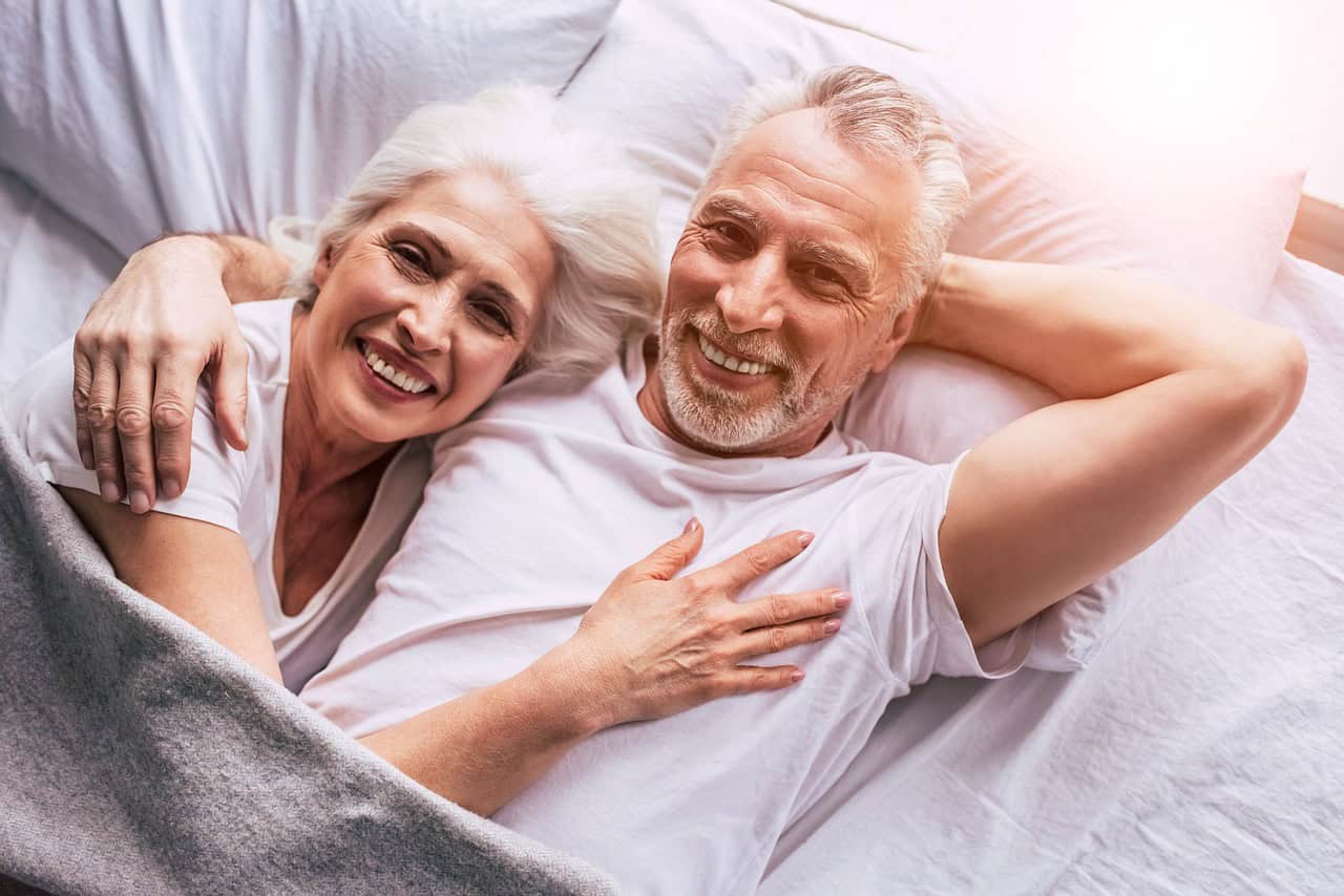 A smiling older couple relaxing together at home