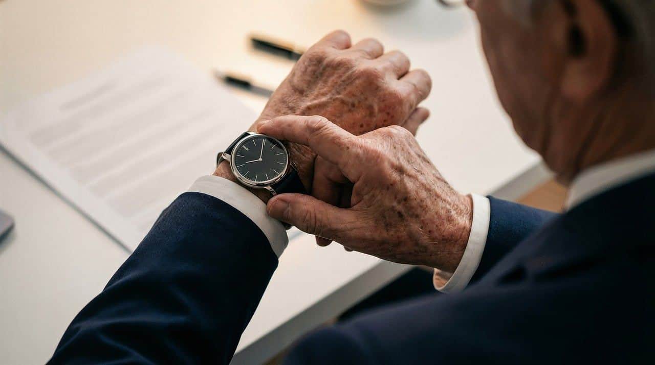 An older man checking his watch